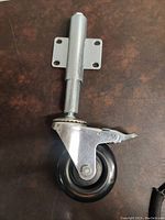 Side view of the full length castor wheel showing the steel frame and black urethane wheel.