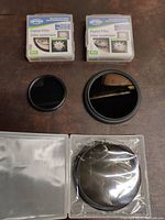 Two camera lens filters (one 46mm, one 72mm) with their original QFTEX Digital Filter boxes and one filter in plastic packaging.