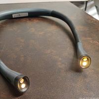 Photo showing amber (warm) light mode illuminated on neck lamp ends