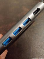 Side view showing three blue USB 3.0 ports and HDMI output on the USB-C hub.