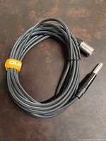 Full view of 25ft black braided shielded cable coiled, showing XLR male and 1/4" TS connectors.