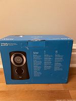 Box front showing Logitech Z313 speaker system with peak power 50W and image of a satellite speaker