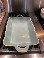 Top view of turquoise glazed rectangular baking dish showing interior and handles.