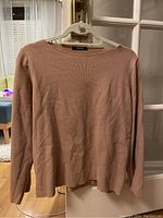 Front view of light brown/tan Zara sweater, displaying ribbed knit texture and boat neckline on hanger
