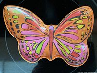 Top view of colorful butterfly-shaped dish with Andy Warhol signature