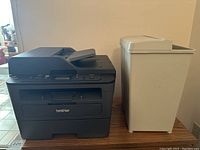 Front view showing Brother printer alongside white paper shredder