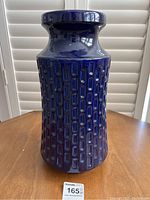 Front view of the tall cobalt blue vase showing textured rectangular pattern and overall shape.