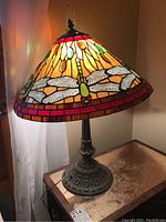 Full view of table lamp lit on side table