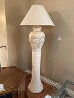 Full view of the pottery floor lamp showing textured ceramic base and fabric shade