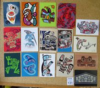 Top view of 20 blank First Nations inspired postcards, showing a variety of colorful wildlife and symbolic designs in traditional style.