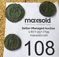 Three bronze Roman coins arranged on MaxSold paper.