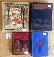 Top view showing all four antique books with detailed cover art and title.