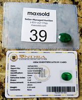 Gemstone and its IGL certification card showing details like shape, measurement and weight