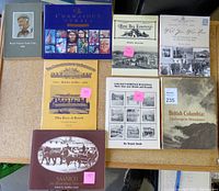 Overview of all nine books on a table showing titles and general condition