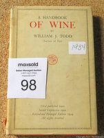 Cover of the book showing the title 'A Handbook of Wine' by William J. Todd, with a publication date label of 1934 and auction lot number sticker.