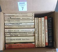 Books laid flat in a box showing titles and vintage condition.