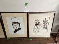 Two framed drawings side by side, one portrait of WC Fields and one of two figures in elaborate hats.