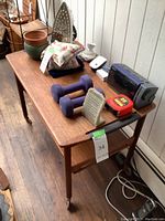 Full view of teak rolling cart with various items on top