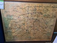 Full view of vintage Paris map mounted on board with wooden frame, showing detailed metro lines and city layout.