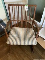 Full front view of wooden rocking chair with cushion