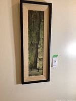 Full view of framed painting hanging on wall