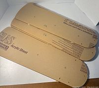 Four vintage Rohm & Haas acrylic sheets stacked, showing protective brown paper covering with printed branding and product details.