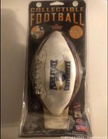 Photo of unopened Penn State University collectible football with packaging, front view showing packaging text and football logo