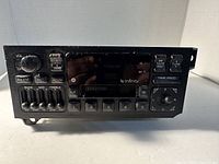 Front view of Chrysler Infinity car stereo with volume knob, equalizer sliders, preset buttons, tape slot, and control buttons.