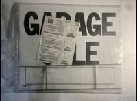 New sealed garage sale sign with visible text 'GARAGE SALE' and packaging shown.