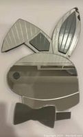 Front view of the vintage Playboy bunny mirror showing mirror surface, ears with etched lines, and bow tie detail
