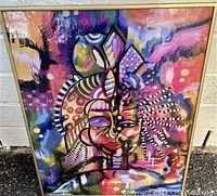 Full view of Sonia Issacs signed print in gold-tone frame showing abstract colorful face artwork.