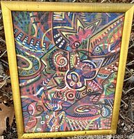 Full view of the framed abstract print showing colorful geometric and organic shapes in various colors.