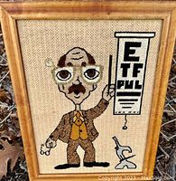 Full view of framed fabric art with eye doctor, eye chart, and microscope