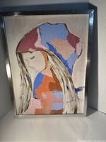 Frontal view of the framed abstract portrait artwork showing a woman's profile with signature at the bottom right.