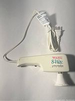 Full view of Wahl 8-Way 2-Speed Massager with power cord and plug showing branding and general condition.