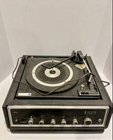 Front angled view of Zenith turntable showing control knobs and tonearm.