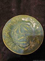 Top view of the plate showing detailed embossed leaf pattern and green glaze