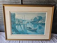 Full view of framed Peggy's Cove harbor print with boats and piers in blue tones.