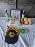 Full view of all items including lamps, owls, game box, small figurines, and cap