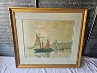 Overall front view of framed artwork showing sailboat scene and gilt wood frame