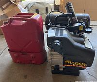 Trades Pro air compressor 3HP 5 gallon unit with vintage metal gas can visible beside it