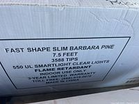 Close-up photo of the box label detailing the tree specs: 7.5 feet tall, 3588 tips, 550 UL Smartlight clear lights, flame retardant, indoor use only, 3-year limited warranty, made in China.