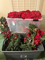 Top photo showing plastic bin filled with 10 faux red poinsettias and garlands underneath with greenery, pinecones, and red berries.