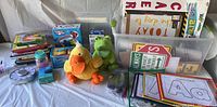 Overview of preschool teaching supplies including puppets, books, flashcards, teaching aids, and packaged new items.