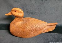 Side profile of the duck decoy showing detailed carved feathers and painting.