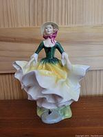 Front view of Royal Doulton figurine showing detailed facial features, clothing and pose.