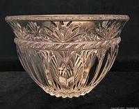 Side view showing intricate cut glass floral and vertical patterns on bowl