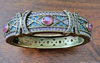 Front view of the hinged cuff bracelet showing amber crystals and bead work
