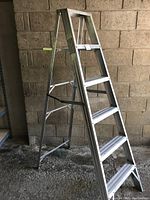 Full view of the aluminum folding step ladder showing structure and steps