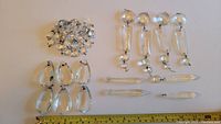 All crystal pieces laid out on white background with measuring tape showing sizes